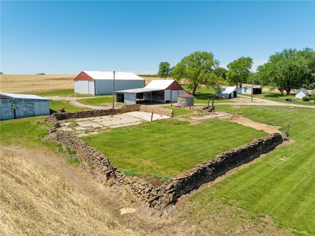 4933 SE Stubbs Rd, Tecumseh, KS 66542 - view of green lawn with a pole building, driveway, and an outbuilding