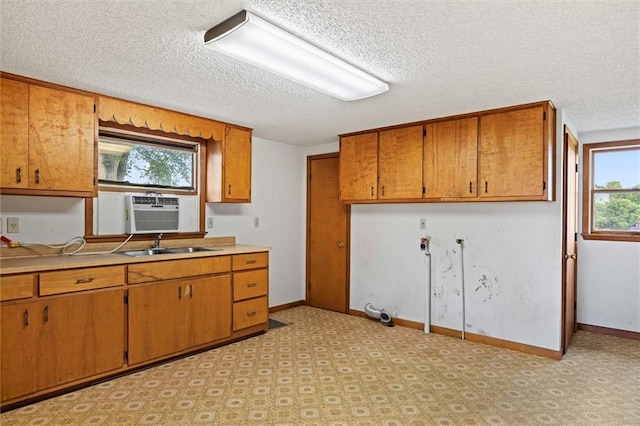 4933 SE Stubbs Rd, Tecumseh, KS 66542 - kitchen featuring brown cabinets, light countertops, a textured ceiling, and cooling unit