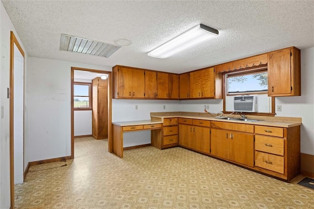 4933 SE Stubbs Rd, Tecumseh, KS 66542 - kitchen featuring brown cabinetry, a textured ceiling, light countertops, and healthy amount of natural light