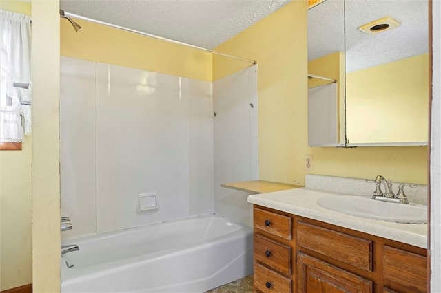 4933 SE Stubbs Rd, Tecumseh, KS 66542 - bathroom with vanity, bathing tub / shower combination, and a textured ceiling