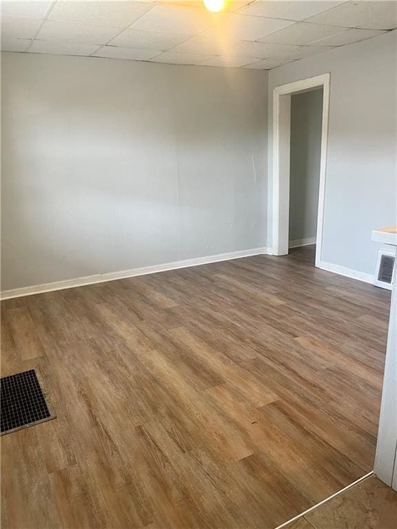 913 Vine St, Saint Joseph, MO 64503 - unfurnished room featuring a paneled ceiling, wood finished floors, baseboards, and visible vents