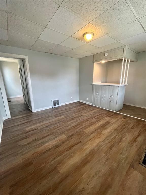 913 Vine St, Saint Joseph, MO 64503 - below grade area with dark wood-type flooring, baseboards, a drop ceiling, and visible vents