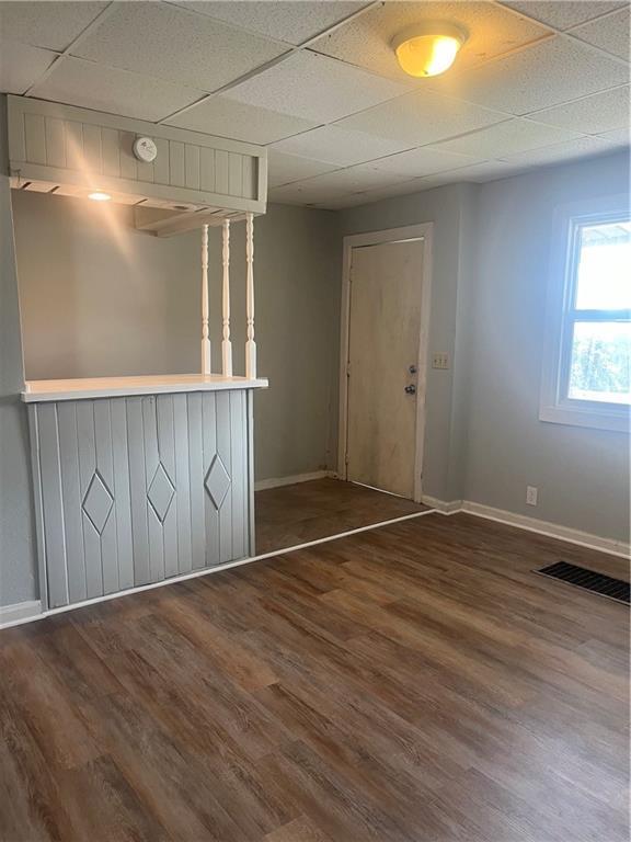 913 Vine St, Saint Joseph, MO 64503 - empty room featuring baseboards, a paneled ceiling, and wood finished floors