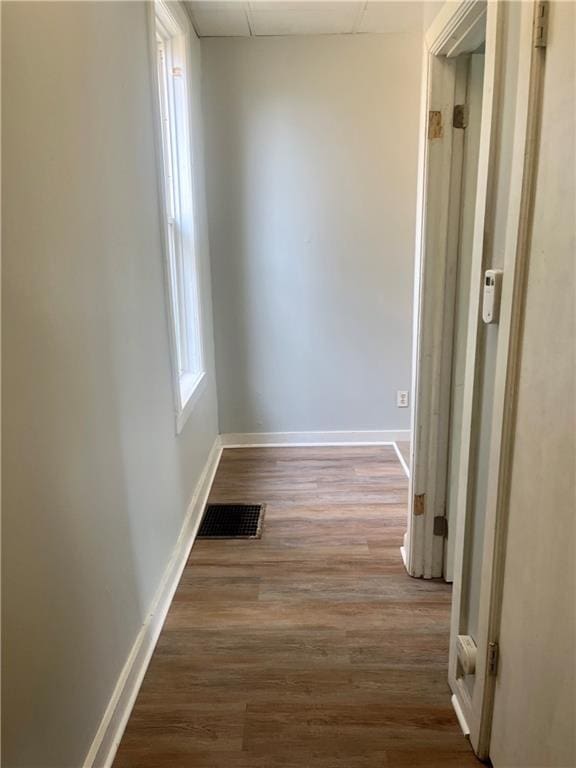 913 Vine St, Saint Joseph, MO 64503 - corridor with visible vents, baseboards, a paneled ceiling, and wood finished floors