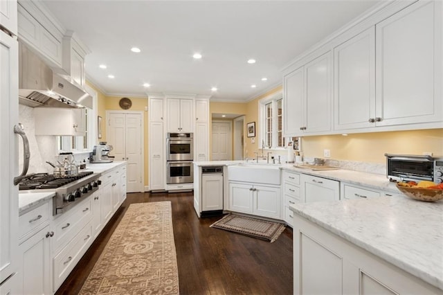 5801 Ward Pkwy, Kansas City, MO 64113 - kitchen with a toaster, appliances with stainless steel finishes, white cabinetry, dark wood finished floors, and ornamental molding