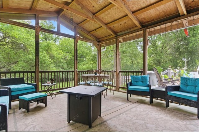 16524 Horton St, Stilwell, KS 66085 - sunroom / solarium with outdoor lounge area, lofted ceiling, and view of wooded area