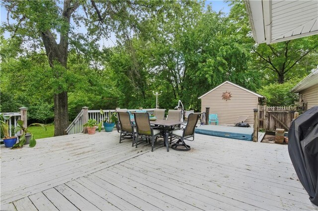 16524 Horton St, Stilwell, KS 66085 - wooden terrace with outdoor dining space and view of scattered trees