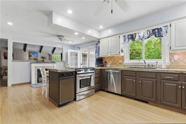 16524 Horton St, Stilwell, KS 66085 - kitchen featuring stainless steel appliances, ceiling fan, a sink, light wood-style flooring, and white cabinetry