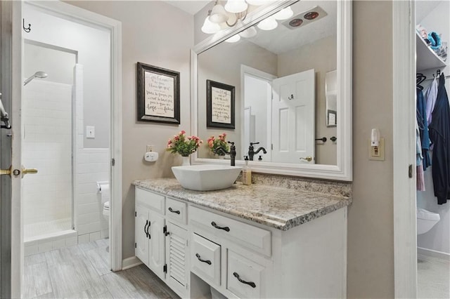 16524 Horton St, Stilwell, KS 66085 - full bathroom featuring vanity, toilet, a stall shower, a spacious closet, and baseboards