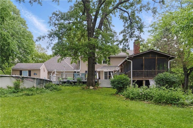 16524 Horton St, Stilwell, KS 66085 - back of house with a sunroom, a deck, a lawn, a chimney, and an outdoor pool