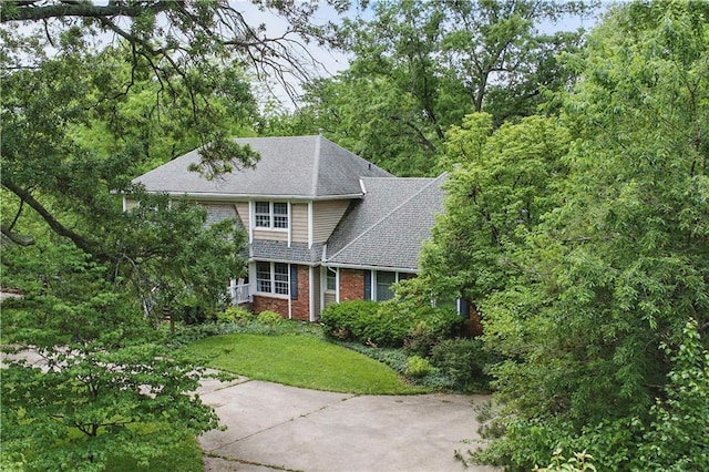 16524 Horton St, Stilwell, KS 66085 - view of front of property featuring brick siding, a front yard, and roof with shingles