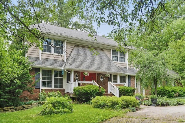 16524 Horton St, Stilwell, KS 66085 - view of front of house with a porch and brick siding