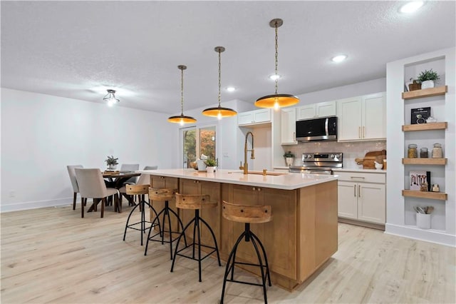 1808 SW 3rd St, Lees Summit, MO 64081 - kitchen with appliances with stainless steel finishes, light wood-style floors, decorative backsplash, light countertops, and open shelves