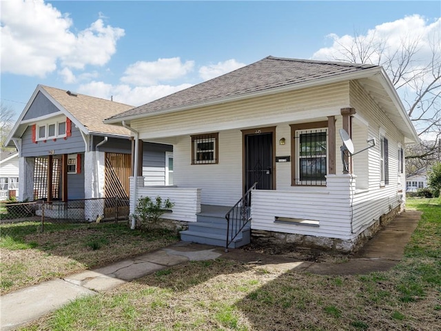 bungalow-style house featuring a shingled roof and a porch