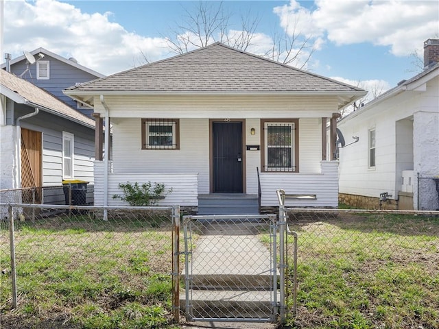 view of front facade with a gate, a front yard, a fenced front yard, roof with shingles, and a porch
