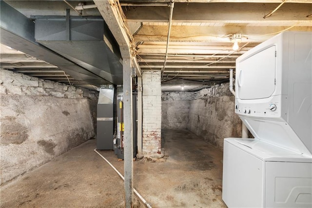 unfinished below grade area with stacked washer and clothes dryer