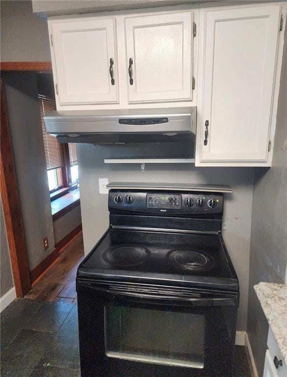 4015 Benton Blvd, Kansas City, MO 64130 - kitchen view of black range with electric cooktop, range hood, and white cabinetry