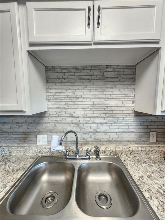 4015 Benton Blvd, Kansas City, MO 64130 - kitchen view of decorative backsplash, white cabinetry, and light stone counters