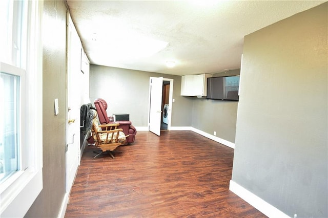 4015 Benton Blvd, Kansas City, MO 64130 - sitting room featuring washer / dryer, dark wood-style floors, and a textured ceiling