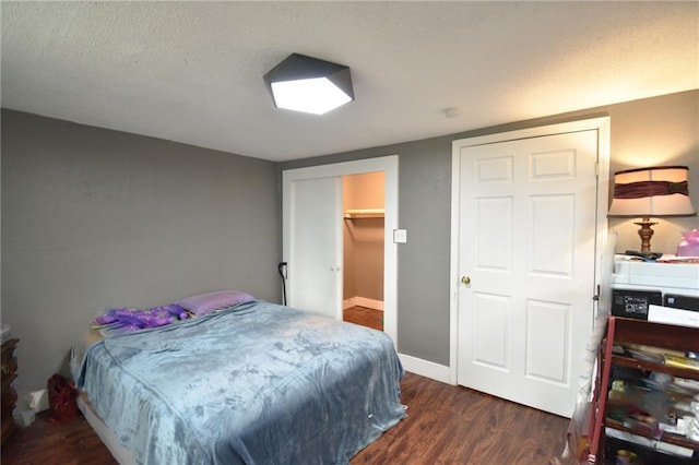 4015 Benton Blvd, Kansas City, MO 64130 - bedroom featuring dark wood-style flooring and a textured ceiling