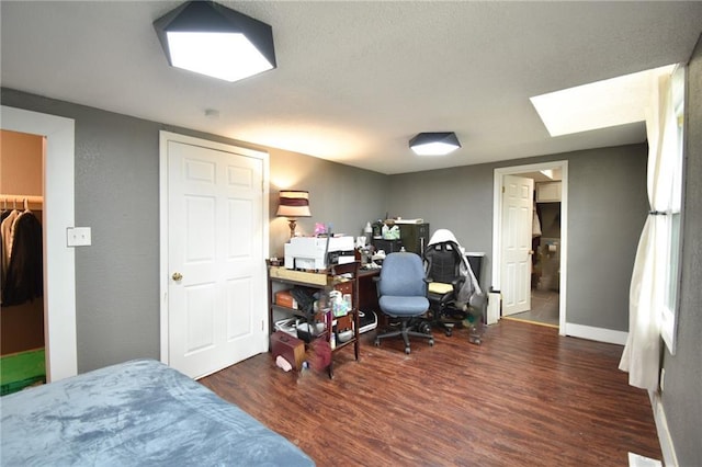 4015 Benton Blvd, Kansas City, MO 64130 - bedroom featuring wood finished floors, an office area, and a textured ceiling