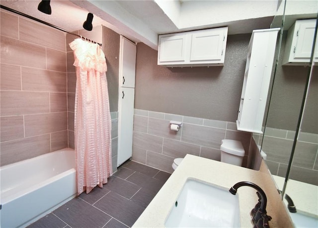 4015 Benton Blvd, Kansas City, MO 64130 - bathroom with tile walls, shower / tub combo with curtain, vanity, and tile patterned floors