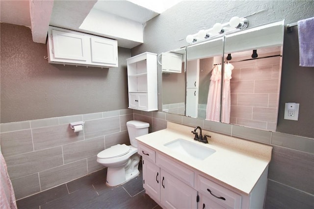 4015 Benton Blvd, Kansas City, MO 64130 - full bathroom featuring tile walls, vanity, and a shower with curtain