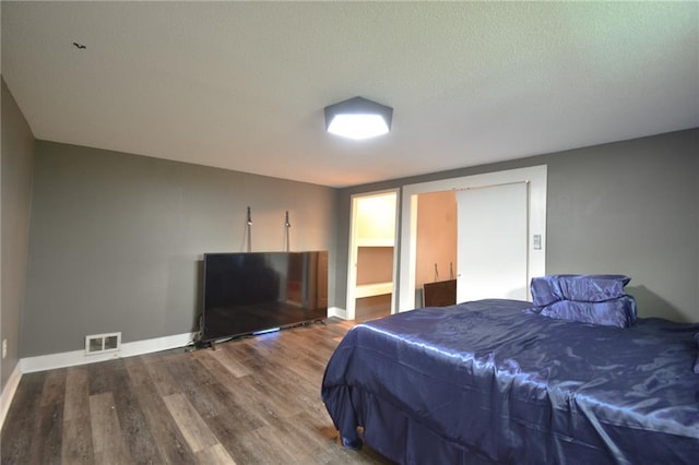 4015 Benton Blvd, Kansas City, MO 64130 - bedroom featuring wood finished floors and a textured ceiling