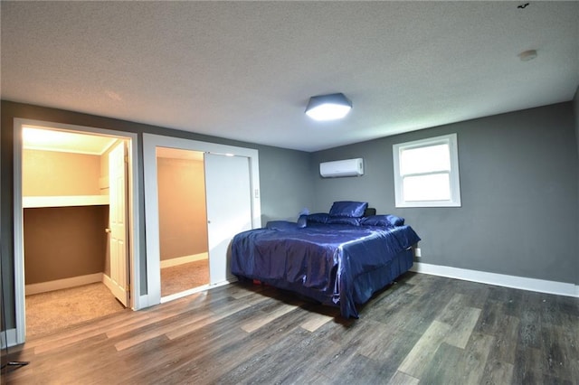 4015 Benton Blvd, Kansas City, MO 64130 - bedroom featuring a wall mounted air conditioner, wood finished floors, and a textured ceiling