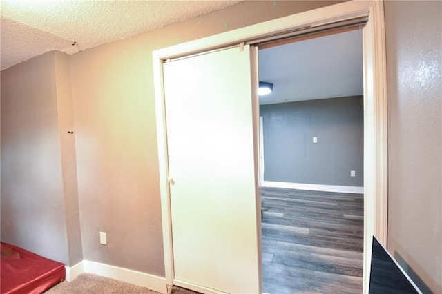 4015 Benton Blvd, Kansas City, MO 64130 - hallway with a textured ceiling and wood finished floors