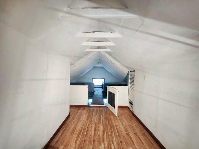 4015 Benton Blvd, Kansas City, MO 64130 - additional living space with wood finished floors, lofted ceiling, and a heating unit