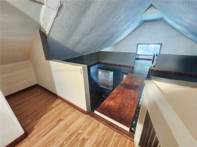 4015 Benton Blvd, Kansas City, MO 64130 - bonus room with wood finished floors, vaulted ceiling, and a textured ceiling