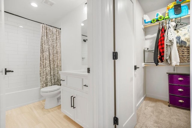 full bath featuring visible vents, vanity, toilet, recessed lighting, and shower / bath combo