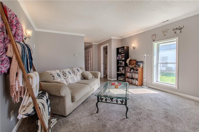 carpeted living room featuring visible vents, ornamental molding, baseboards, and a textured ceiling