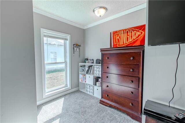 carpeted bedroom featuring baseboards, a textured ceiling, and crown molding