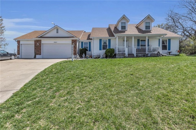 view of front of house featuring covered porch, driveway, an attached garage, and a front yard