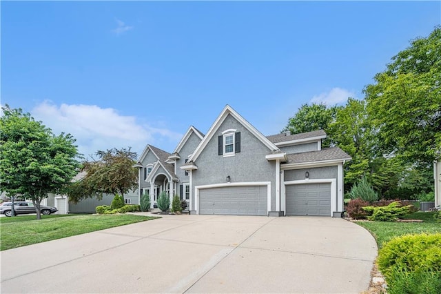 7325 Oakview St, Shawnee, KS 66216 - traditional home featuring driveway, stucco siding, an attached garage, and a front lawn