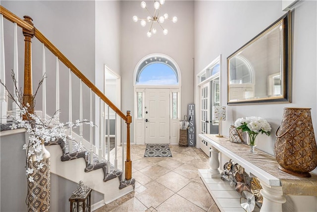7325 Oakview St, Shawnee, KS 66216 - foyer with stairway, a towering ceiling, a chandelier, and light tile patterned floors