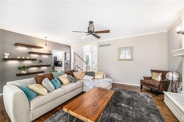 7325 Oakview St, Shawnee, KS 66216 - living area with ornamental molding, stairs, dark wood finished floors, ceiling fan, and arched walkways