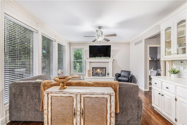 7325 Oakview St, Shawnee, KS 66216 - living room with a ceiling fan, a lit fireplace, dark wood-style floors, and crown molding