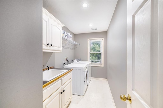 7325 Oakview St, Shawnee, KS 66216 - washroom featuring washing machine and dryer, cabinet space, recessed lighting, and light tile patterned flooring