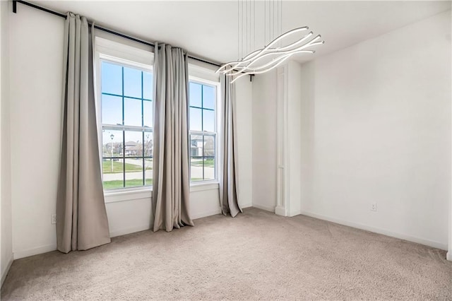 spare room with baseboards and carpet flooring
