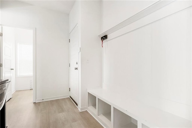 mudroom featuring light wood-style flooring and baseboards