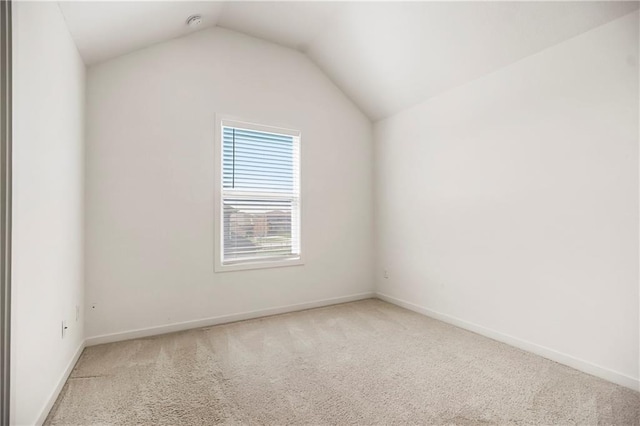 interior space featuring baseboards, vaulted ceiling, and carpet flooring