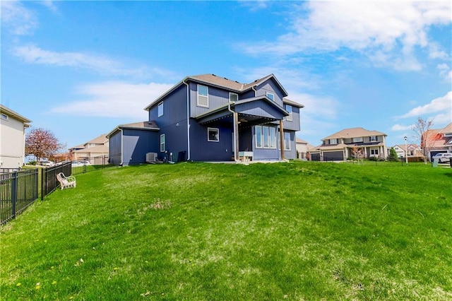 back of property with a yard, central air condition unit, and fence