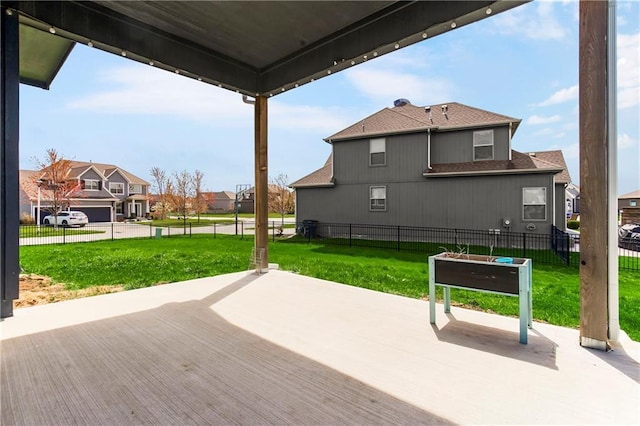 wooden deck featuring fence, a yard, and a residential view