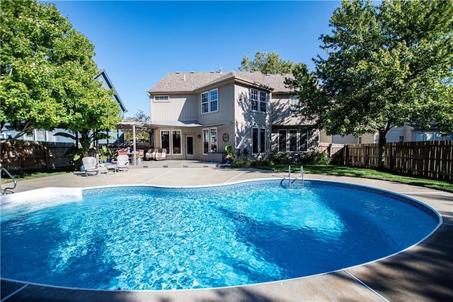 view of pool with a patio area, fence, and a pergola