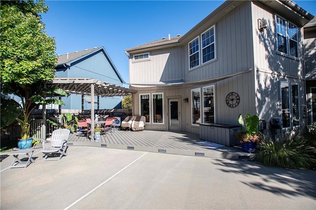 rear view of house featuring a pergola and a patio