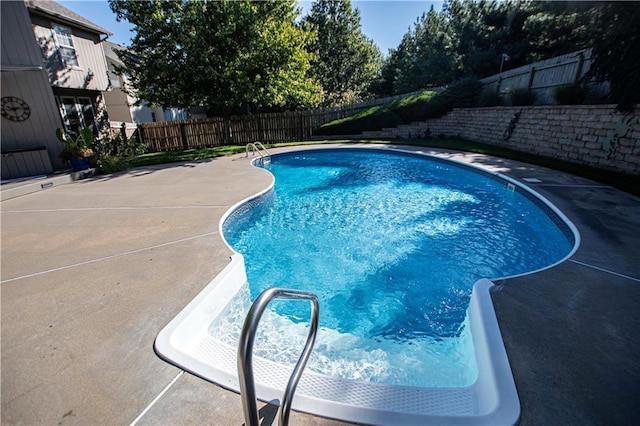 view of pool featuring a fenced backyard and a patio