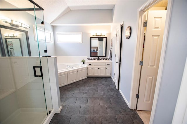 bathroom with a stall shower, a garden tub, vaulted ceiling, and vanity